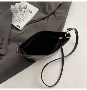 Top view of deep reddish-brown bucket bag interior showing gold zipper and lining
