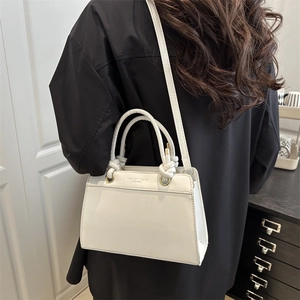 Minimalist white faux leather tote bag featuring knotted handles and fashion print for women