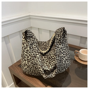 Detail of leopard print canvas tote bag with zipper closure and large capacity hobo design