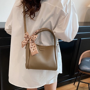 Brown litchi pattern leather crossbody bag with a checkered silk scarf on the handle