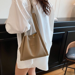 Brown lychee texture leather tote bag with Fashion embossing shown on model