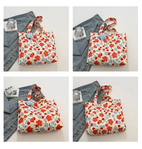 Detailed view of floral canvas tote bag with plush star charm and large capacity