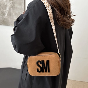 Brown suede camera bag with SM letter detail and geometric patterned wide strap
