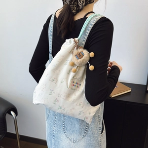 Floral canvas drawstring backpack with bunny print and brown plush bear keychain