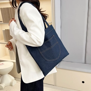 Stylish large capacity deep blue denim tote bag with front pocket and orange stitching