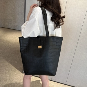 Large black crocodile embossed tote bag with gold buckle and wide shoulder strap