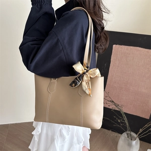 Minimalist beige tote bag with chic printed silk scarf and durable faux leather finish