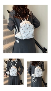 Three-way view of white floral mini backpack with plush cloud charm and golden zippers
