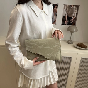 Chic pistachio green envelope clutch with pleated texture and golden metal buckle for women
