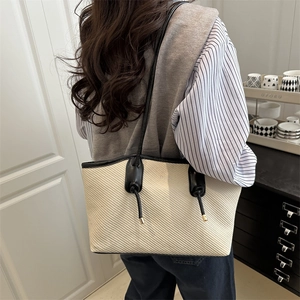 Chic beige woven tote bag with black piping and double rope knot detail for women