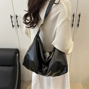 Minimalist large black crescent shoulder bag with adjustable strap for daily commuting