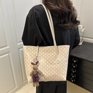 Women's large tote bag in beige with M-pattern print and a cute plush rabbit pendant
