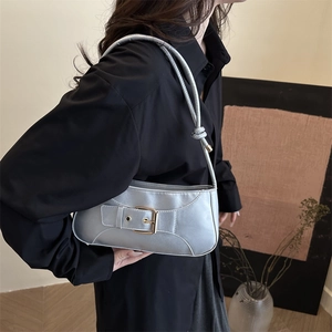 Silver metallic baguette underarm bag with gold buckle detail and shoulder knot