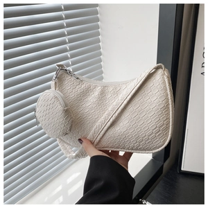 Detail view of woven textured cream hobo bag with a matching round coin purse pouch