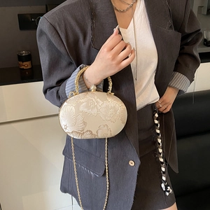 Elegant white crossbody bag with floral embroidery and golden top handle for women