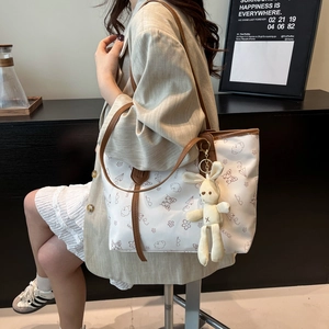 White floral tote bag with cute cartoon bears and plush rabbit charm for daily commuting