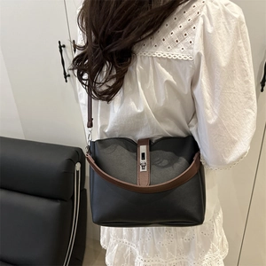 Fashionable black and brown contrast leather bucket bag for women with silver hardware