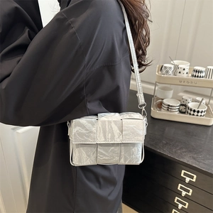 Silver metallic woven crossbody bag with large check weave and chic adjustable shoulder strap