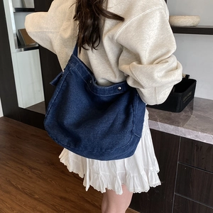 Japanese style large capacity washed denim crossbody bag shown on a model
