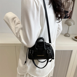 Mini black lychee pattern bucket bag with gold lettering and drawstring closure