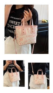 Detailed close-up of pink bear graffiti prints and metal studs on the cream crossbody bag