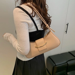 Minimalist beige crescent shoulder bag with gold metal buckle and leather shoulder strap