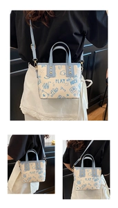 Detail showing graffiti prints and light blue trim on a stylish large capacity crossbody bag