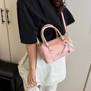 Pink snake-texture Boston bag with pearl bow and crossbody strap for stylish women