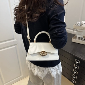 White vintage-style shoulder bag for women with gold V-shape buckle on a chic flap