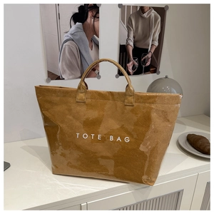 Detailed view of brown tote bag with wrinkled paper texture and waterproof coating