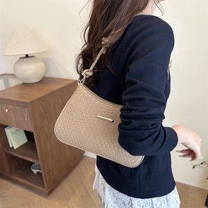 Minimalist light brown woven shoulder bag for women with elegant golden metal detail