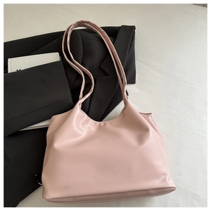 Pink PU leather tote bag shown on a white cloth with a black blazer for a stylish look