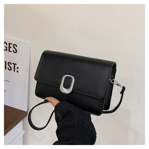 Detailed macro view of the sleek black PU leather bag with matte silver oval metal buckle