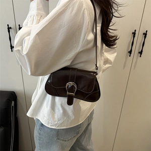 Minimalist brown faux leather underarm bag with silver buckle and sleek vintage design