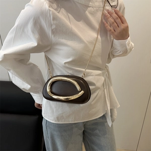 Women's dark brown crossbody box bag with modern irregular gold metal buckle and chain strap