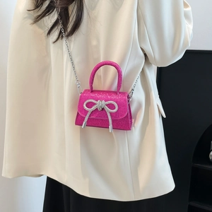 Pink sequin mini crossbody bag with crystal bow detail and silver chain strap