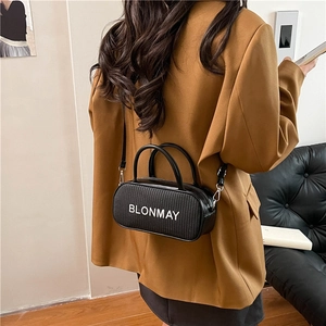 Retro black cylindrical shoulder bag with brand logo and silver metallic hardware hooks