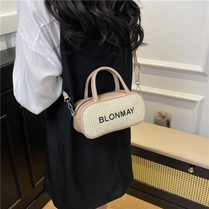 Beige cylindrical crossbody bag with woven texture and dual handles for a casual look