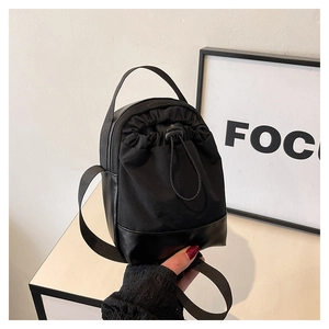 Detail of premium black nylon crossbody phone bag with drawstring and leather base