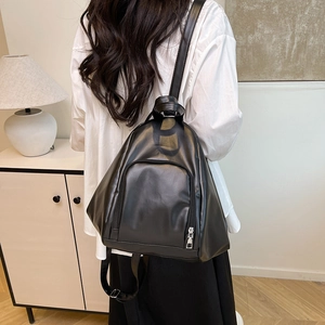 Minimalist black PU leather backpack with triangle design and silver zippers for daily use