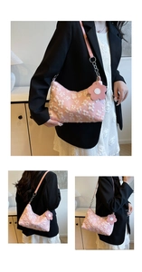Detail of pink floral embroidered hobo bag featuring 3D flowers and leather chain strap