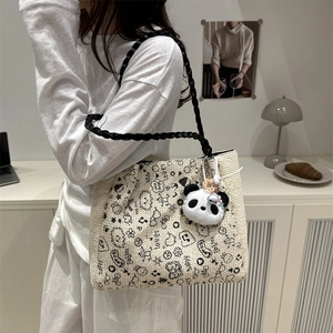 Beige tote bag with black cartoon graffiti patterns and cute panda plush pendant