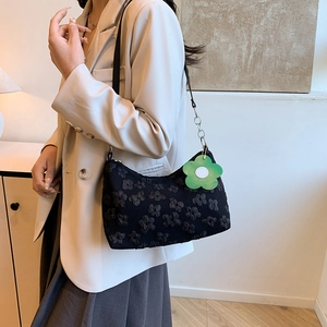 Floral embossed black underarm bag with green charm for 2025 spring fashion style