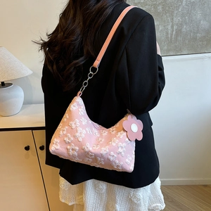 Pink hobo bag with white 3D floral lace embroidery and silver chain on model