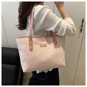 Pink striped tote bag with butterfly embroidery and golden hardware detail on shoulder