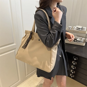 Fashionable beige large tote bag with silk scarf and tennis racket charm for women