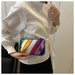 Close-up of rainbow striped crossbody bag with metallic colors and silver chain strap