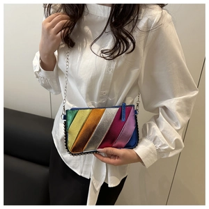 Close-up of rainbow striped crossbody bag with silver beaded trim and metal chain strap
