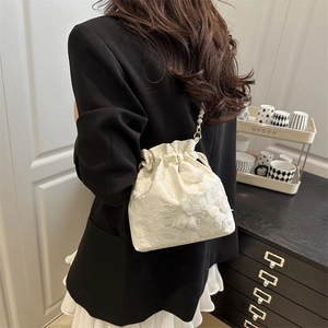 White lace drawstring bucket bag with floral embroidery and elegant pearl handle strap