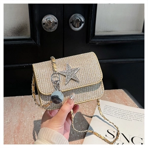 Detail of champagne gold mini crossbody bag with star rhinestone and diamond mesh texture